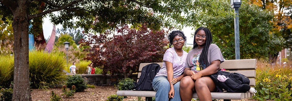 Campus shot, student on bench